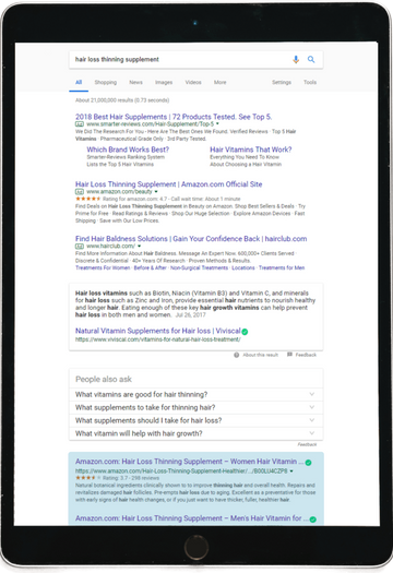 Search results on a tablet of hair loss supplements