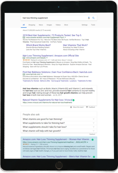 Search results on a tablet of hair loss supplements