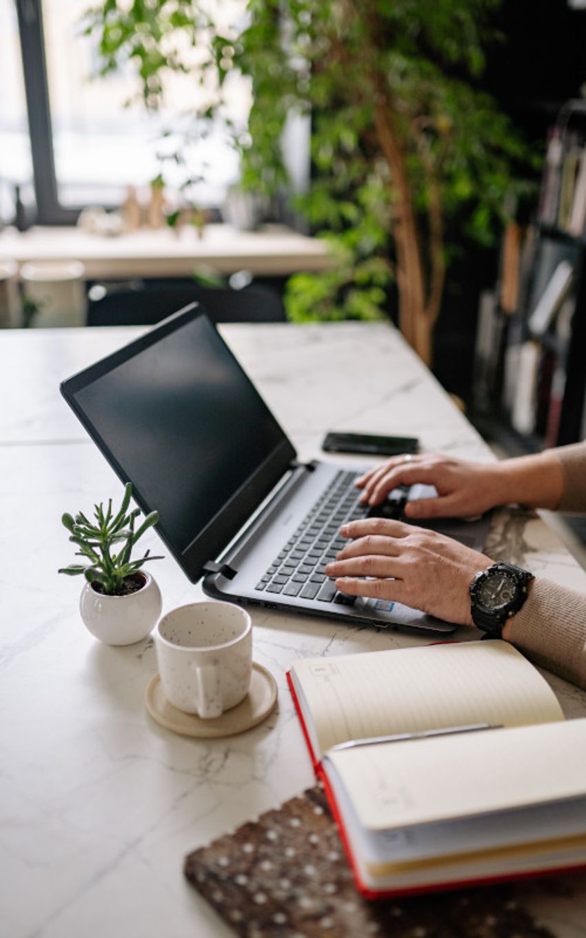 Person typing on a laptop in a office like room